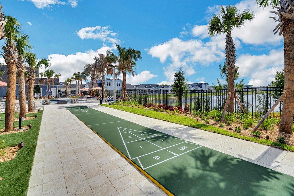 a playground in a community with palm trees at The Sophia, Florida