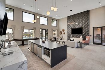 a kitchen with a large center island next to a living room with a couch and a tv  at The Sophia, Florida, 34275