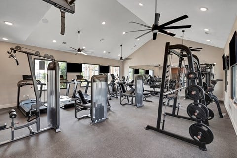 a spacious fitness center with cardio equipment and a large window  at The Sophia, Florida, 34275