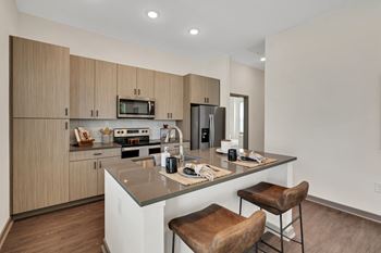 a kitchen with a large island with two stools  at The Sophia, Florida