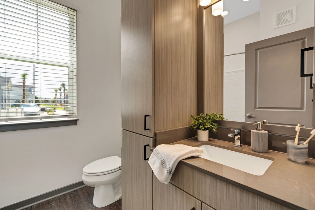 a bathroom with a toilet sink and mirror  at The Sophia, Venice