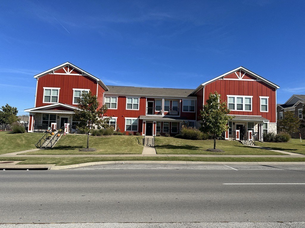 a red house on the side of a street