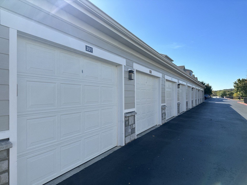 a row of white garage doors on a building