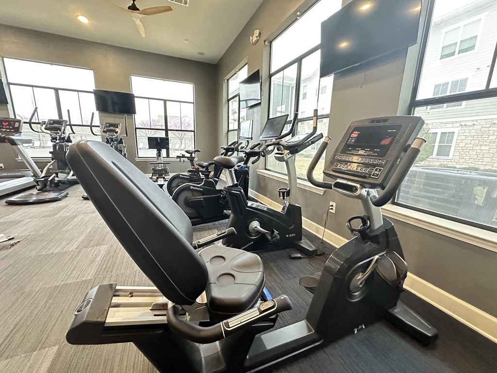 a gym with cardio equipment and windows in a building at Watermark at Steele Crossing, Fayetteville, 72703