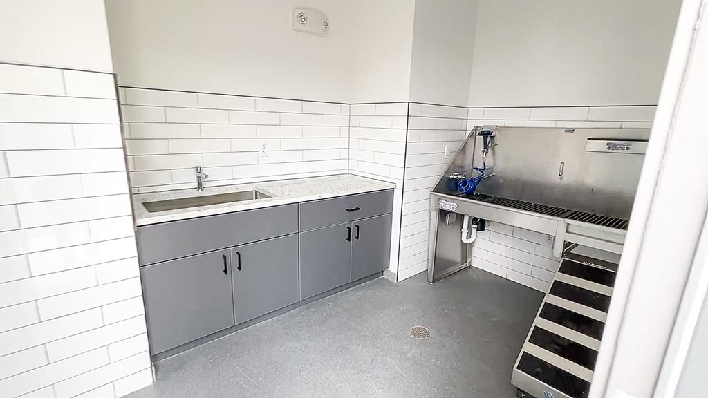 a kitchen with a sink and a stove in it at The Depot, Raymore, Missouri