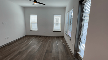 A room with wooden flooring and a ceiling fan.