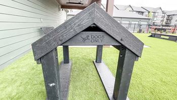 a dog house with a sign that says dogs only at The Depot, Raymore, MO, 64083