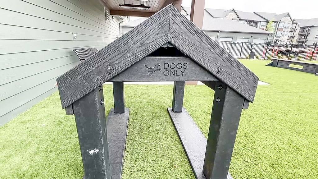 a dog house with a sign that says dogs only at The Depot, Raymore, MO
