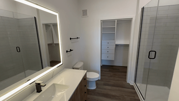 A white sink with a mirror above it.