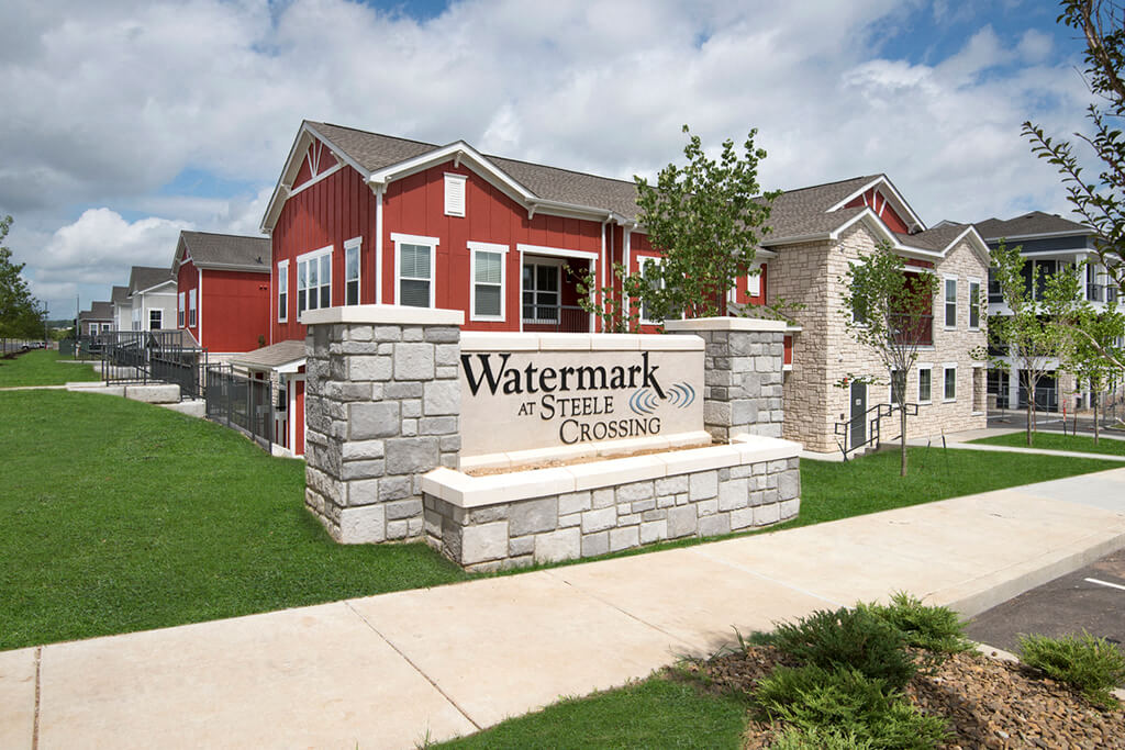 a view of the watermark at steel crossing sign in front of a building