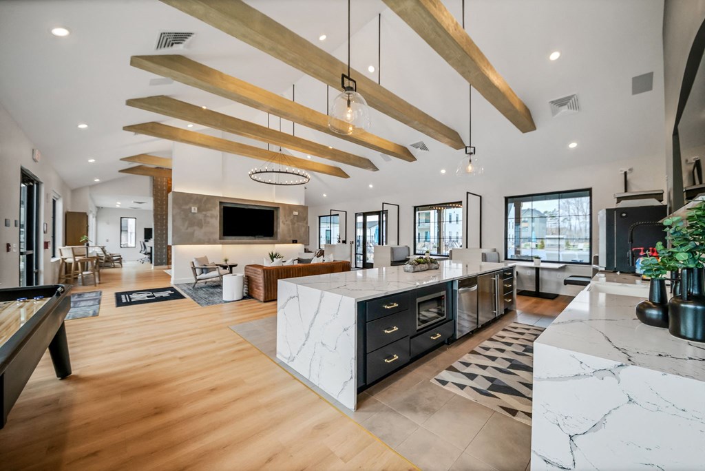 the kitchen is open to the living room and dining room at The BLVD at Wilson Crossings, Wyoming, MI