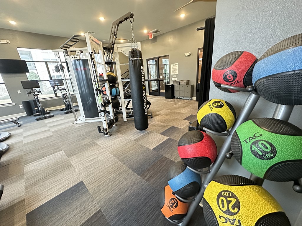 a gym with weights and a punching bag on a rack at Watermark at Steele Crossing, Fayetteville