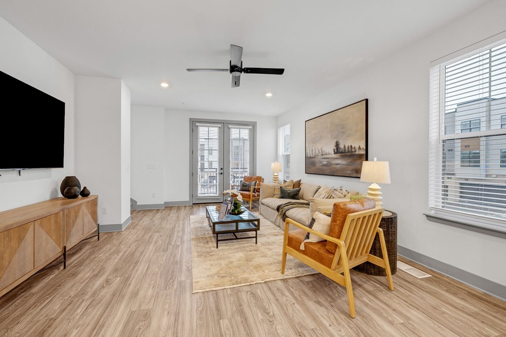 a living room with a couch and a tv at Meridian at CityPlace, Woodbury, MN
