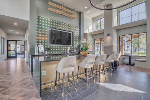 a kitchen with a bar with chairs and a television at Canter, Ocala, FL, Florida