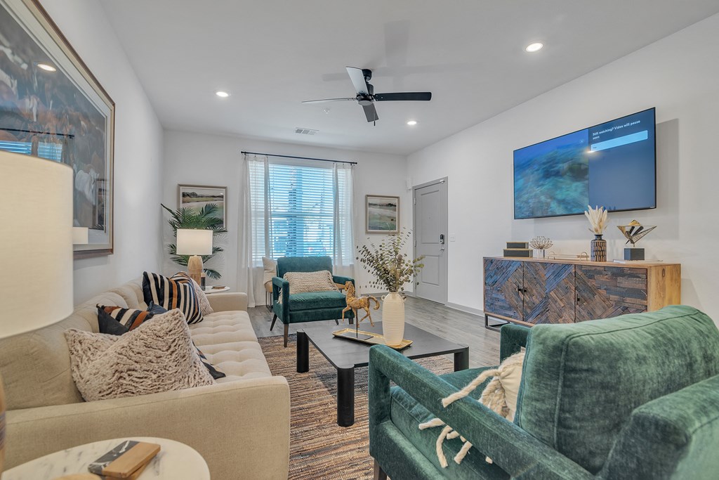 a living room with couches and chairs and a tv at Canter, Ocala, 34474