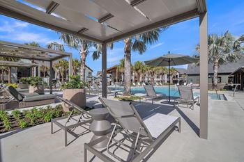 A poolside area with a canopy and lounge chairs at Canter, Ocala, FL, Florida