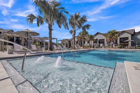 a swimming pool with palm trees and houses in the background at Canter, Ocala, Florida