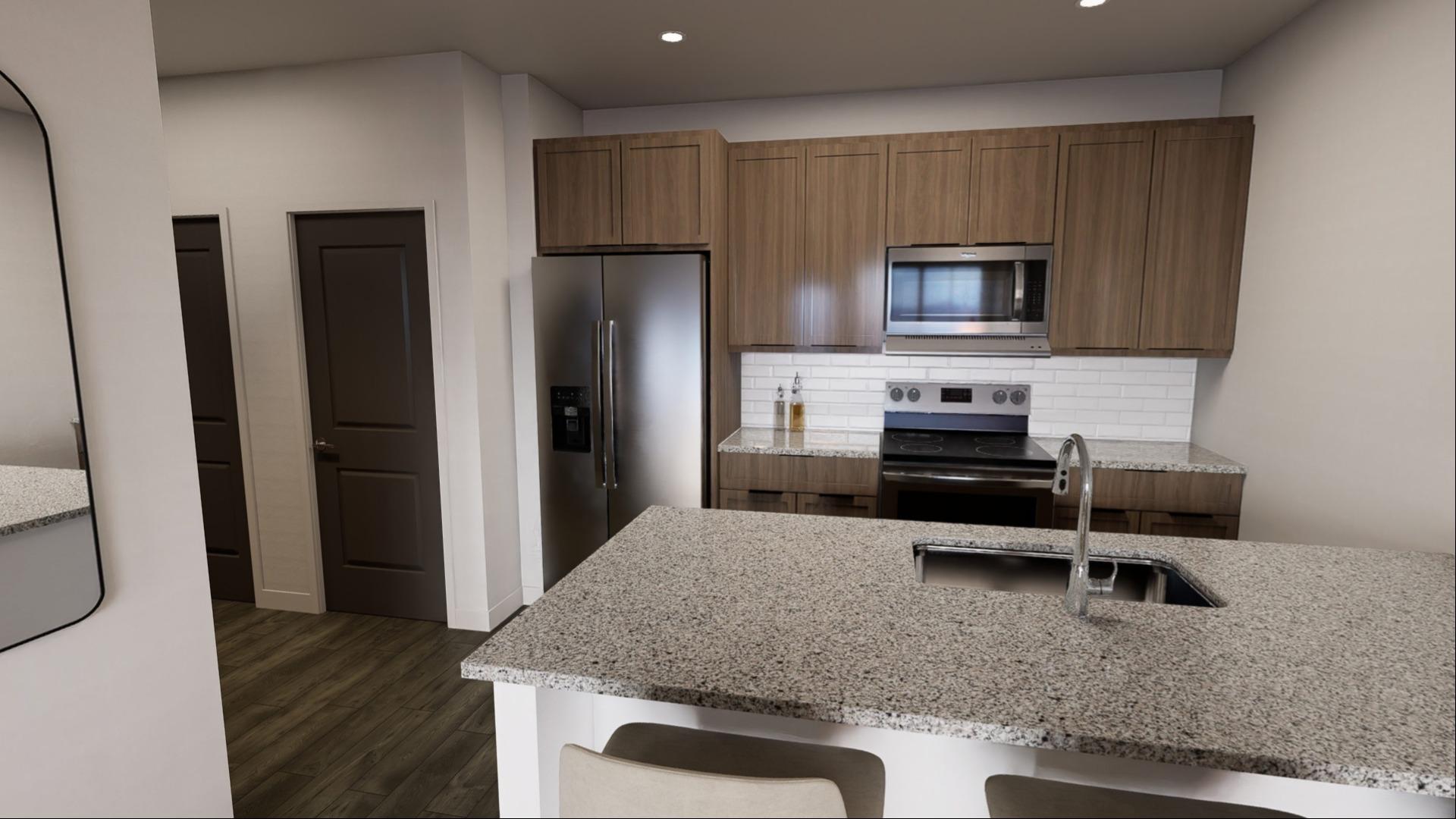 A kitchen with a granite countertop and a microwave above the stove.