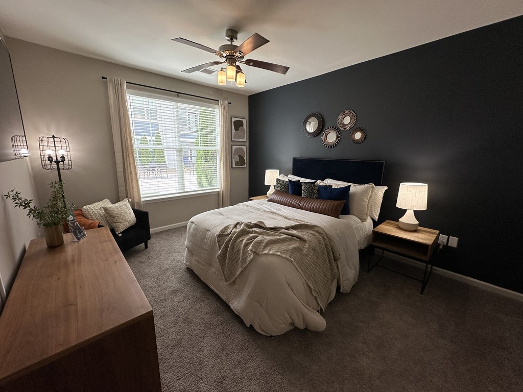 a bedroom with a large bed and a ceiling fan at Watermark at Steele Crossing, Fayetteville, 72703