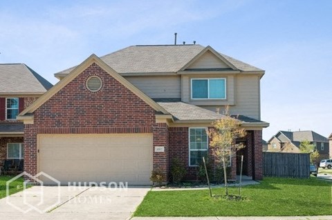 a house with a garage door and a lawn
