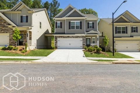 a house with a driveway and a garage door in front of it