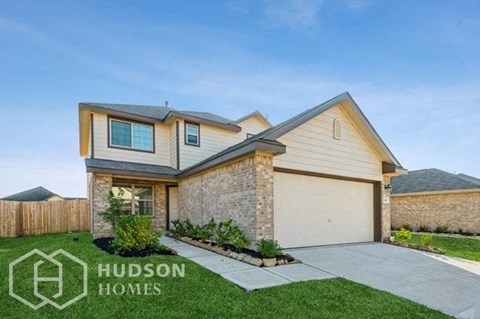 a house with a garage door and a lawn