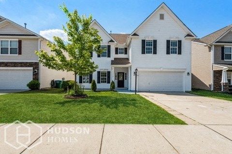 a white house with a lawn in front of it