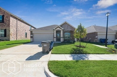 a house with a yard and a driveway in front of it