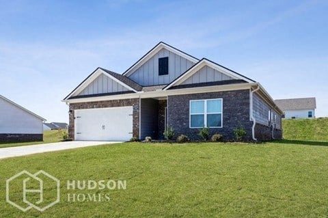 a brick house with a lawn in front of it