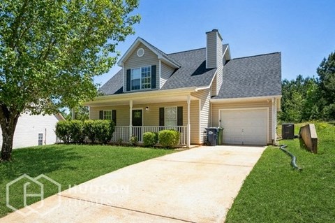 a white house with a driveway and a garage door