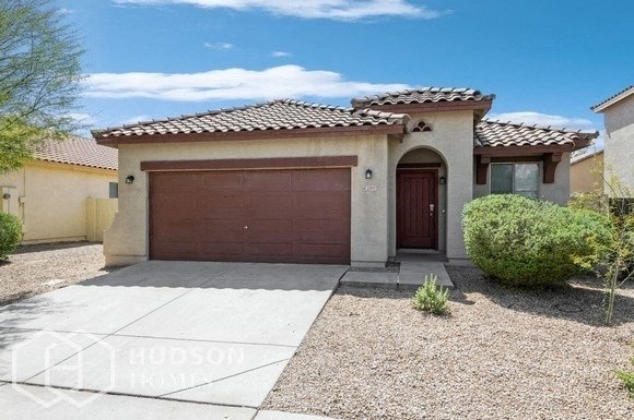 a house with a garage door and a driveway