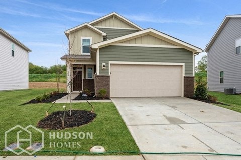 a house with a driveway and a garage door