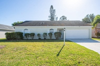 Hudson Homes Management Single Family Home For Rent 3230 6th Ave W Palmetto Florida 34221 Attached Garage Back Yard 3 bedrooms 2 bathrooms