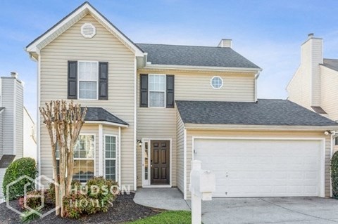 a beige house with a white garage door