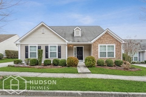 a house with a lawn and a sidewalk in front of it