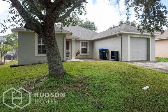 Hudson Homes Management Single Family Home For Rent Pet Friendly 404 Hope Circle Orlando Florida 32811 attached garage vaulted ceilings 4 bedroom back yard dishwasher - Photo Gallery 1