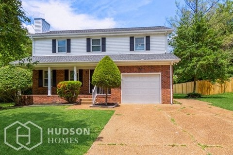a house with a driveway and a white garage door