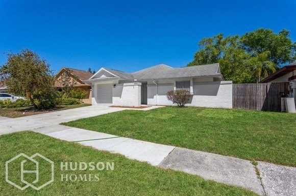 a white house with a lawn and a sidewalk