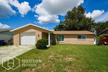 Hudson Homes Management Single Family Home For Rent Pet Friendly 6301 Baldwyn Ave New Port Richey Florida 34653 attached garage dishwasher microwave back patio back yard 2 bathrooms