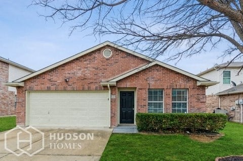 a brick house with a white garage door