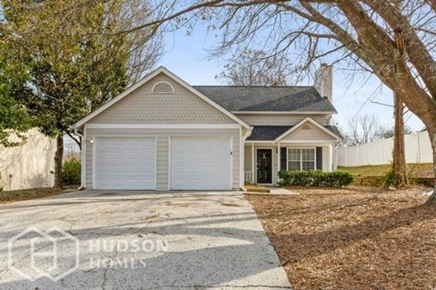 a home with a white garage door and a driveway