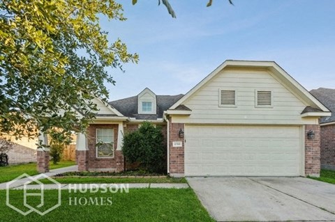 a house with a white garage door and a lawn