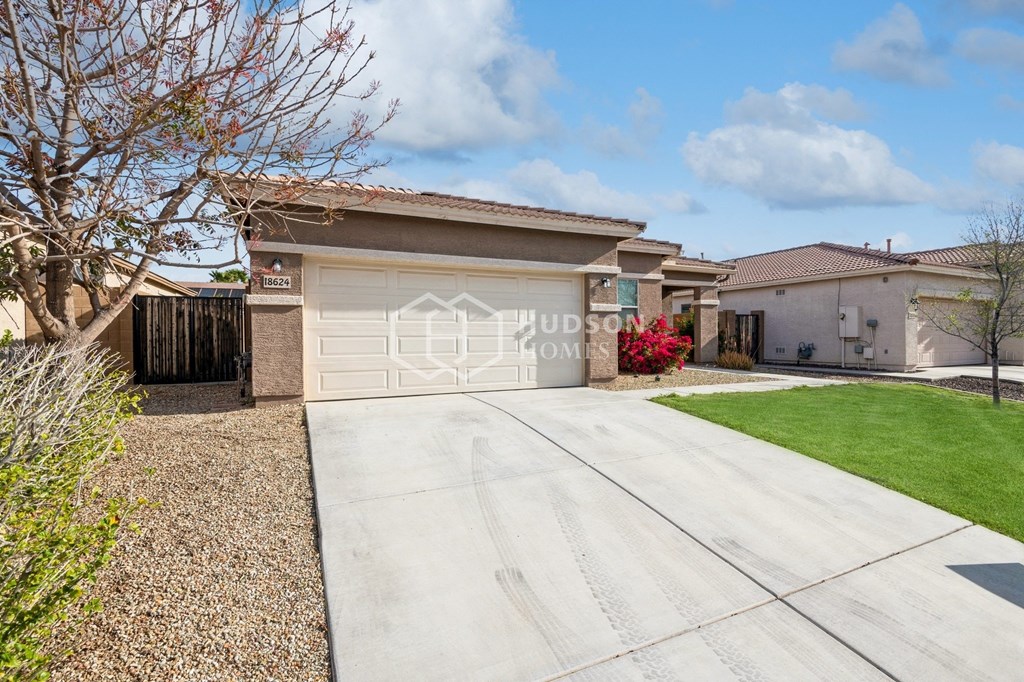 a home with a driveway and a white garage door