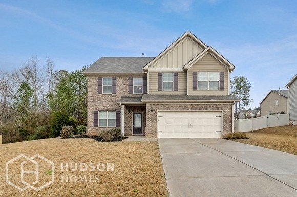a brick house with a white garage door
