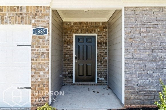 a front door of a brick house with a porch