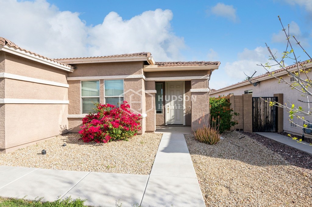 a remodeled home with a walkway to the front door