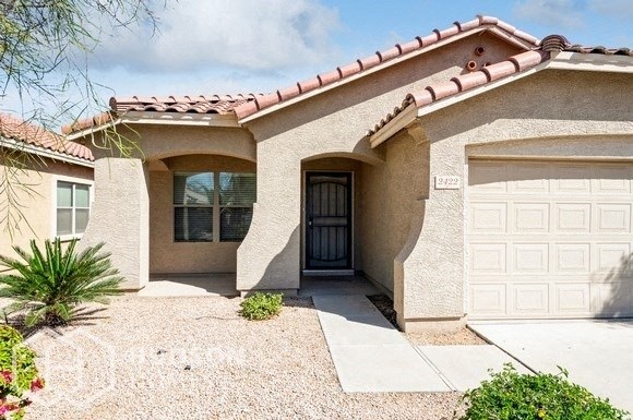 a home with a garage door and a white garage door