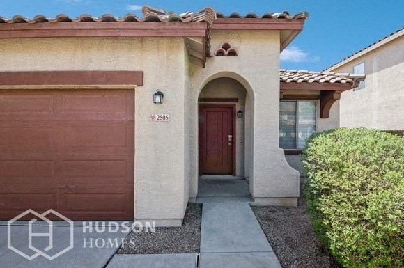 a house with two garage doors and a door way