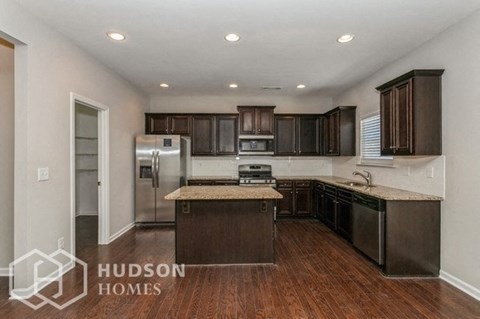 a kitchen with stainless steel appliances and a counter top