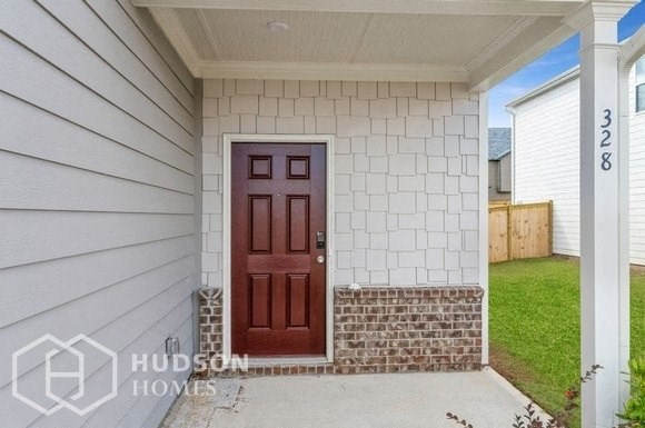 a front door of a white house with a porch